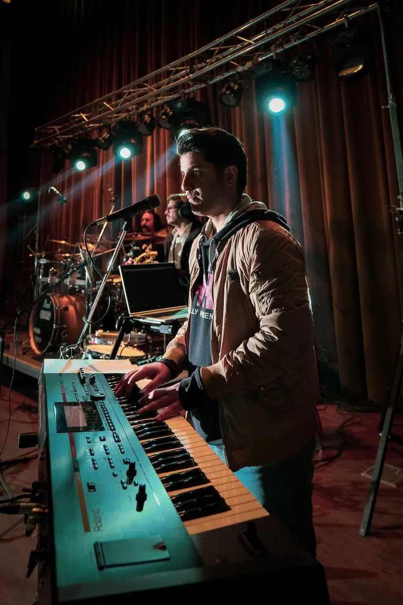 man in white dress shirt playing piano